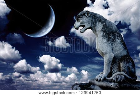 Ancient lion statue and bright moon in the night sky. Elements of this image furnished by NASA