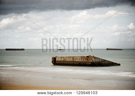 Ruins of harbor built by the Allies in Arromanches, Normandy, France.