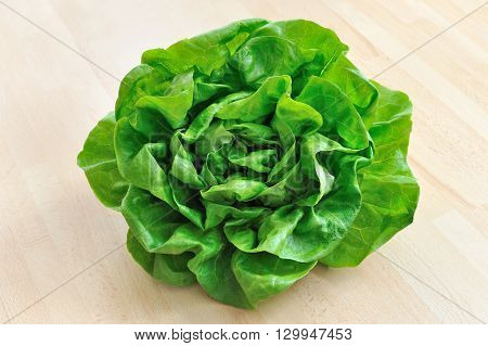 fresh green lettuce from above on wooden table