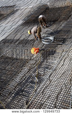 Workers Construct The Iron Rods For The Baseplate Of The Building