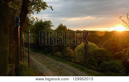 Sunset in village Mseno with fence and house