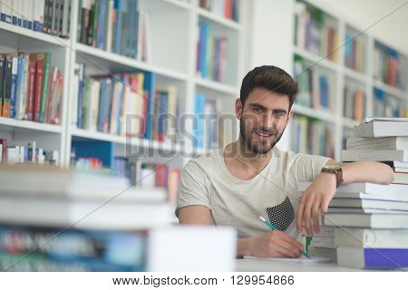 Student reading book in school library. Study lessons for exam. Hard worker and persistance concept.