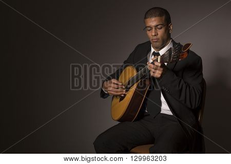 fado musician with a portuguese guitar, studio