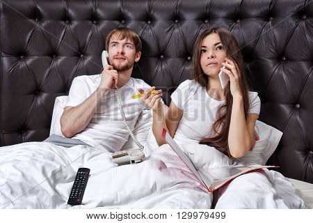Morning business couple. Husband and wife on the phone. Family business. Viewing on TV Morning stock price.