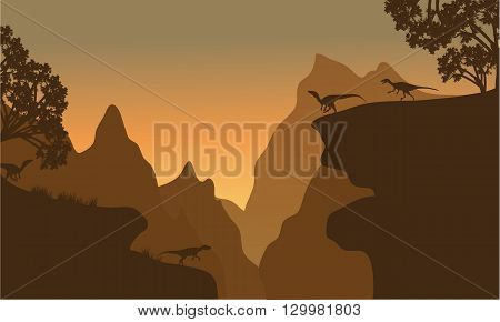 Silhouette of eoraptor in cliff with brown backgrounds