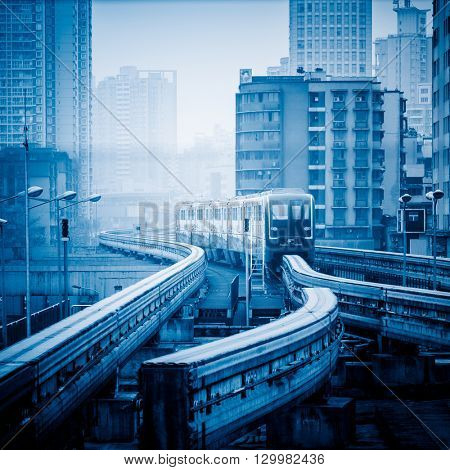 moving metro monorail in chongqing,china,blue toned image.