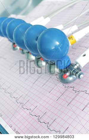 ECG electrodes on the printed graph. Unusual angle view