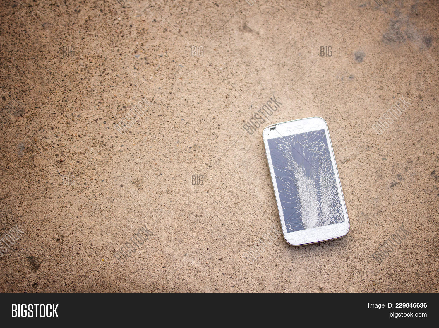 Top View Of Broken Mobile Phone Drop On Cement Floor With Copy Space For Desing Top View Of Broken Mobile Phone Drop On Cement Floor With Copy Space For Desing