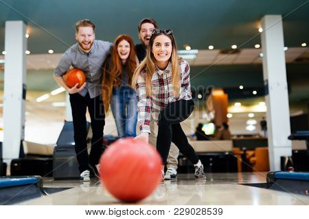 Friends Having Fun While Bowling And Speding Time Together