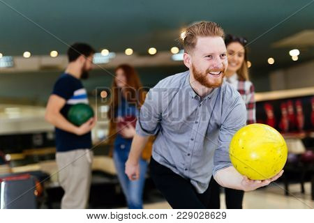 Friends Having Fun While Bowling And Speding Time Together