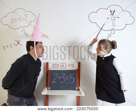 Little Girl Teaching Mathematics To An Adult Dunce On Little Chalkboard