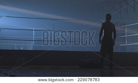Back View Of Young Boxer On Grunge Background. Fighter Man Silhouette Dark. Mma Fighter Silhouette O