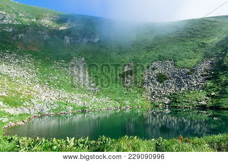 The Blue Lake Brebeneskul Among Carpathians Mountains