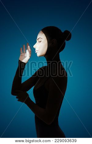 Silhouette With Bright Spots Of A Girl On A Blue Background