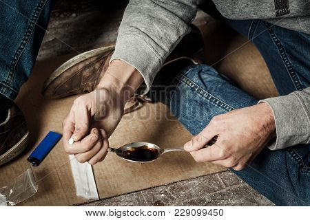 Addict Man With A Syringe In Action. The Concept Of Drug Abuse And Traffic
