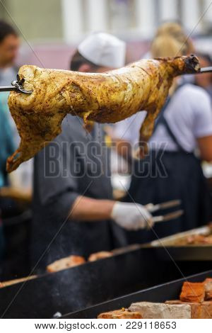 Carcass Of Sheep, Suckling Pig On Rotating Spit With Fire On Spit, Bbq. Summer Picnic, Nutrition, Di