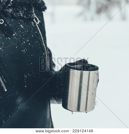 Partial View Of Woman Holding Thermocup With Hot Drink On Winter Day