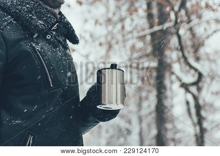 Partial View Of Woman Holding Thermocup With Hot Drink On Winter Day
