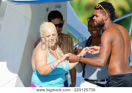 Santo Domingo, Dominican Republic - October 29, 2015: Local Dominican Man Teaching Female Tourist Me