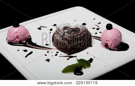 Dessert Fondan Chocolate With Ice-cream On A White Plate On A Black Background. Exquisite French Cho