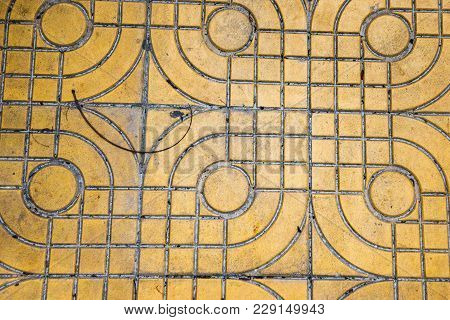 Purple And Yellow Patterned Paving Tiles On The Street, Top View. Cement Bricks, Squared Stone Groun