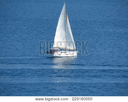 Sailboat In The Aegean Sea. White Sail