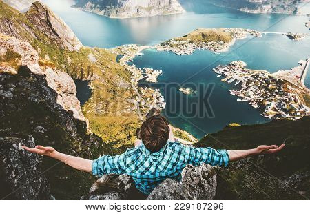 Happy Man Raised Hands On Cliff Edge Traveling In Norway Reinebringen Mountain Aerial View Adventure