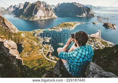Man Traveler Taking Photo By Smartphone Traveling In Norway Lifestyle Concept Adventure Outdoor Sitt