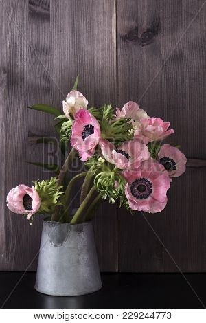 Wedding Bouquet Of Anemones With Ruscus In A Jug On A Black Background