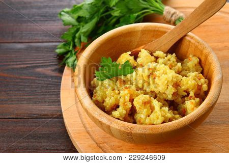 Rice Pilaf With Chicken, Spices And Parsley In A Bowl On A Wooden Table