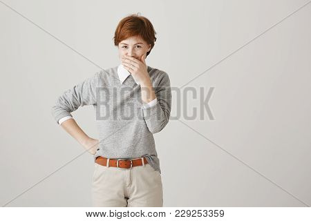 Boss Is Shouting And Employee But She Can Not Hold Laugh. Indoor Shot Of Positive Cute Redhead Woman