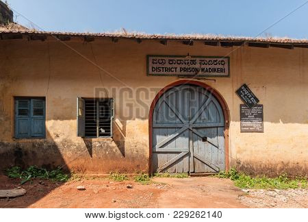 Madikeri, India - October 31, 2013: The Wooden, Blue-gray Entrance Door  And Part Of Orange Facade O