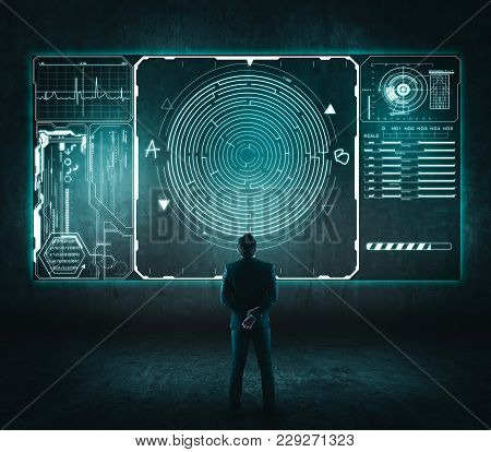 Business Concept. Back View Of Businessman Looking At A Maze On Touch Screen