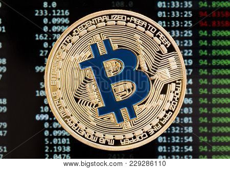 Golden Bitcoin Cryptocurrency Blue Coin On A Circuit Board Background. High Resolution Photo.