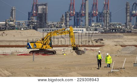Rotterdam, Netherlands - Sep 8, 2012: Construction Workers And A Komatsu Pc240-6 Hydraulic Excavator