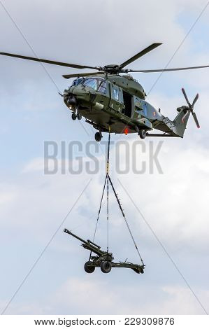 Beauvechain, Belgium - May 20, 2015: Belgian Army Nh90 Helicopter Transporting An Artillery Piece.