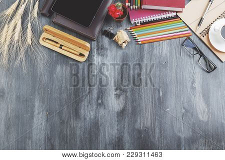 Top View Of Wooden Desktop With Copy Space And Various Items. Work Place And Style Concept