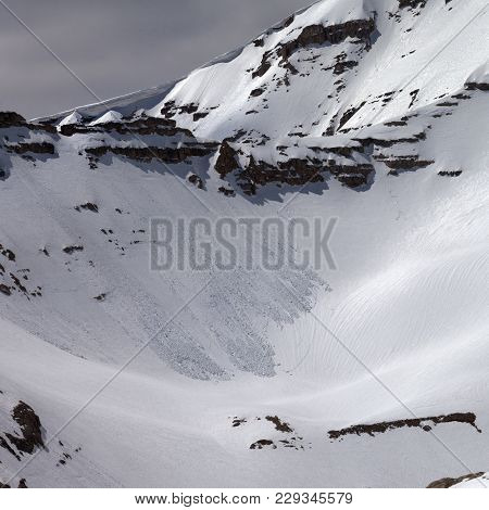 Mountains with snow cornice and traces from avalanches at gray day. Turkey, Central Taurus Mountains, Aladaglar (Anti Taurus) view from plateau Edigel (Yedi Goller)