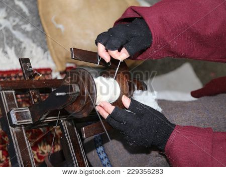 Old Lady Who Weaves A White Thread Using An Old Loom