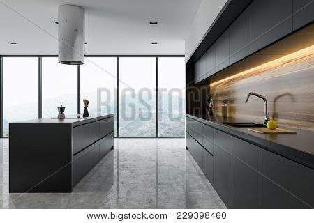 Side View Of A Panoramic Black And Wooden Kitchen Interior With Dark Gray Countertops And An Island.