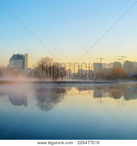 Sunrise In A Foggy Writers' Park In Minsk
