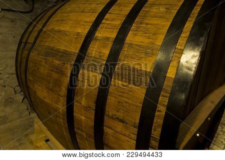 Old Wooden Barrel Close Up. Natural Grunge Textured Barrel. Dark Surface With Old Natural Wooden Pat