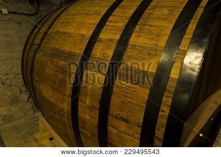 Old Wooden Barrel Close Up. Natural Grunge Textured Barrel. Dark Surface With Old Natural Wooden Pat