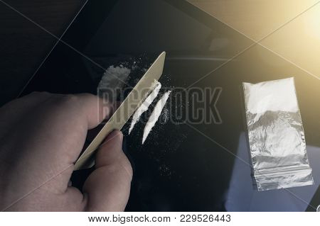 Drug Abuse. Hand Of Man Holds Credit Card For Making Lines Of Cocaine Powder To Sniff. Problems With