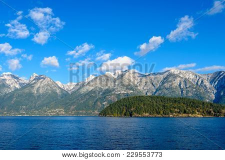 Fantastic view over ocean, snow mountain and rocks at Sechelt inlet in Vancouver, Canada.