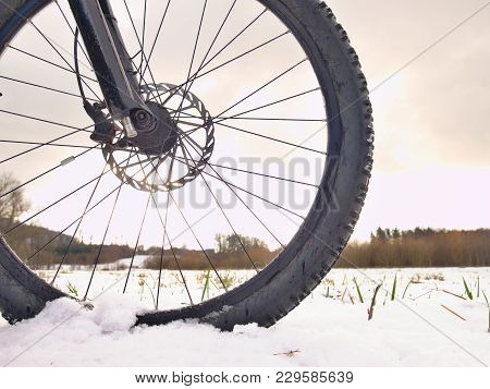 Front Bike Detail On A Winter Trail, Path Covered By Snow. Sportive Backgrounds And Still-life. Biki