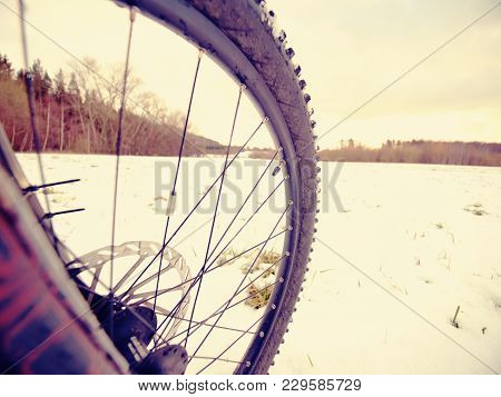 Winter Snow Riding On Mountine Bike. Extreme Weather, Slippery Road In Field, Close Low Ankle Wide V