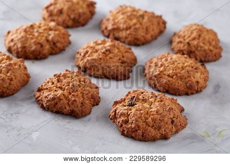 Sweet Cookies With Raisin Arranged In Pile On Light Textured Background, Close-up, Shallow Depth Of 