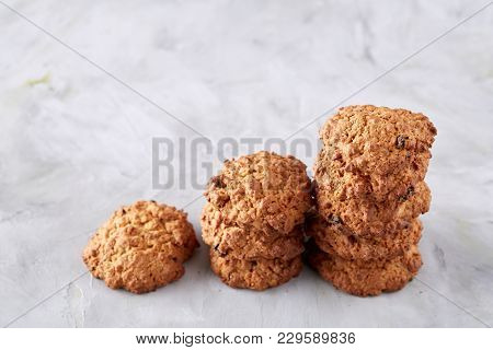 Sweet Cookies With Raisin Arranged In Pile On Light Textured Background, Close-up, Shallow Depth Of 