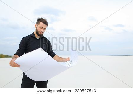 Investor Rent Land For New Amusement Park, Guy Come To Secluded Place With Plan. Young Man Unwrap Wh